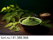 Bowl of moringa powder and fresh leaves on wooden table. AI generated. Стоковое AI-изображение, AI-художник Александра Селина / Фотобанк Лори