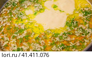 Cheddar cheese soup. Vegetables carrot, potatoes, herbs boiled in a thick broth. White Soup boiling in a saucepan. Preparing Bouillon. Cooking cream broth, making in a steel pot in a kitchen Close-up. Стоковое видео, видеограф Марина Демидюк / Фотобанк Лори