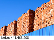 Red bricks stacked into cubes. Warehouse bricks. Storage brickworks products. Стоковое фото, фотограф Леонид Еремейчук / Фотобанк Лори