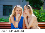 Two young beautiful women secret at summer green park. Стоковое фото, фотограф Андрей Аркуша / Фотобанк Лори