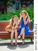 Two young beautiful women secret at summer green park. Стоковое фото, фотограф Андрей Аркуша / Фотобанк Лори