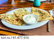 Delicious gourmet flat bread kutabs with herbs and cheese on a plate. Стоковое фото, фотограф Евгений Ткачёв / Фотобанк Лори