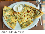 Delicious gourmet flat bread kutabs with herbs and cheese on a plate. Стоковое фото, фотограф Евгений Ткачёв / Фотобанк Лори