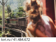 Rear view of tourist lady travel by train to landmarks in Sri Lanka. Traveler woman travelling enjoying extreme fun train ride in tropic country. Touristic journey tropical concept. Copy ad text space (2022 год). Стоковое фото, фотограф Aleksandr Golubev / Фотобанк Лори