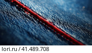 Stitching of a seam on denim clothes in close-up. Generated by AI. Стоковое AI-изображение, AI-художник Ярославский Максим / Фотобанк Лори