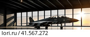 Interior view, a generic military fighter jet, parked, inside a military hangar at sunset. Panoramic banner. AI. Стоковое AI-изображение, AI-художник Sergey Grishin / Фотобанк Лори