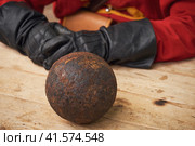 A gunner in vintage Swedish military clothing and cannon balls. Ancient military arsenal of the events of the Russian-Swedish war. Стоковое фото, фотограф Андрей Журавлев / Фотобанк Лори