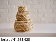 Close-up of three round stream box with lid on white table. Wicker caskets for storage on a white background. Household items. Стоковое фото, фотограф Андрей Журавлев / Фотобанк Лори