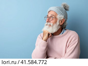 Portrait of an elderly man with a large gray beard and lush hair with a thoughtful look to the side. Blue background. Generated by AI. Стоковое AI-изображение, AI-художник Ярославский Максим / Фотобанк Лори