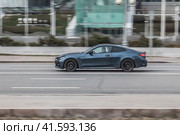 Blue aggressive BMW Sport Car riding with motion blur on the road. Side view of shiny bmw M4 F82 driving in the street. Редакционное фото, фотограф Константин Григорьев / Фотобанк Лори