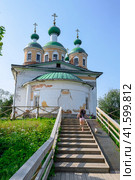 Cathedral of Our Lady of Smolensk and a girl running to it on a wooden staircase in Olonets, Karelia, in summer (2023 год). Стоковое фото, фотограф Сергей Фролов / Фотобанк Лори
