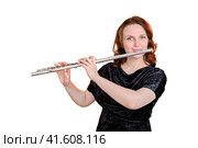 Portrait of a woman musician with a flute on a studio isolated white background. Flutist with a large concert transverse flute in her hands. Стоковое фото, фотограф Андрей Журавлев / Фотобанк Лори