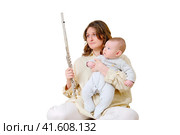 Problems with rehearsals and music lessons after childbirth, isolated on a white background. Sad woman mom with infant baby and flute on home sofa. Стоковое фото, фотограф Андрей Журавлев / Фотобанк Лори