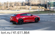 Red car Lamborghini Urus on city street. Редакционное фото, фотограф Константин Григорьев / Фотобанк Лори