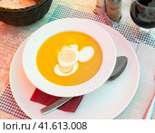 Pureed vegetable soup served with boiled eggs in bowl with spoon and glass of wine. Стоковое фото, фотограф Яков Филимонов / Фотобанк Лори