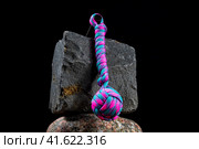 Braided paracord keychain on a background of stones. Handmade, creative design. Стоковое фото, фотограф Артем Лукин / Фотобанк Лори