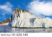 Beautiful winter landscape of frozen Baikal Lake with an icy Cape Kobylia Golova or Horse Head of Olkhon Island on February at sunny cold day. Natural landmark. Winter ice travel. Стоковое фото, фотограф Виктория Катьянова / Фотобанк Лори