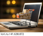 A small cart from the supermarket is on the laptop keyboard. Generated by AI. Стоковое AI-изображение, AI-художник Ярославский Максим / Фотобанк Лори