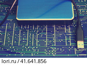 Portable hard disk on the background of the circuit board. Стоковое фото, фотограф Андрей Журавлев / Фотобанк Лори