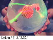 Fortune telling on the crystal ball about the future of coronavirus. Magician influenza virus in a fortune teller's hands. Стоковое фото, фотограф Андрей Журавлев / Фотобанк Лори