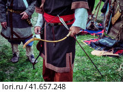 Archer retro tribe stands with a bow in his hand. Reconstruction old life of the nomadic peoples. Bow and arrow for hunting in hand. Стоковое фото, фотограф Андрей Журавлев / Фотобанк Лори