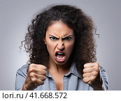 A woman in a state of extreme rage, with clenched fists and jaw, angry, emotional and furious. Generated by AI. Стоковое AI-изображение, AI-художник Ярославский Максим / Фотобанк Лори