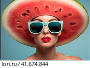A girl in sunglasses and a watermelon-colored straw hat on a blue pastel background. Стоковое AI-изображение, AI-художник Ярославский Максим / Фотобанк Лори