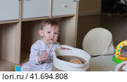 Toddler baby puts small objects in his mouth. The danger of small things getting into the child's mouth. Kid aged ten months. Стоковое видео, видеограф Андрей Журавлев / Фотобанк Лори