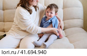 Loving mom selects warm clothes to keep her baby cozy during the walk. Mother provides child with stylish, practical outfits that will keep him warm. Kid aged about two years (one year ten months). Стоковое видео, видеограф Андрей Журавлев / Фотобанк Лори