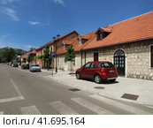 Cetinje, Montenegro - June 24, 2019. Perspective of Baja Pivljanina street with view of crashed car. Улица Бая Пивлянина в Цетине, Черногория. Редакционное фото, фотограф Александр Кузнецов / Фотобанк Лори