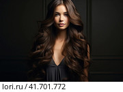 Portrait of a beautiful brunette with long wavy hair on a dark background. Generated by AI. Стоковое AI-изображение, AI-художник Ярославский Максим / Фотобанк Лори