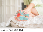 Joint diseases, hallux valgus, plantar fasciitis, woman's leg hurts, pain in the foot, massage of female feet at home. Стоковое фото, фотограф Станислав Тарко / Фотобанк Лори