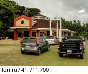 Echang, Palau - July 1, 2018. Parking in front of St. Joseph Church. Церковь Святого Иосифа в поселке Эанг, Республика Палау. Редакционное фото, фотограф Александр Кузнецов / Фотобанк Лори