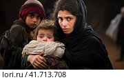 Portrait of Refugees on middle east looking at camera. Homeless people, unhappy and frightened, shawl camps,  Generative AI. Стоковое AI-изображение, AI-художник Анна Кривицкая / Фотобанк Лори