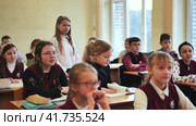 Berezovka, Belarus - September 25, 2023: A junior high student answers at her desk. Редакционное видео, видеограф Mikhail Davidovich / Фотобанк Лори