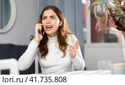 Angry woman arguing while having telephone conversation. Стоковое фото, фотограф Яков Филимонов / Фотобанк Лори