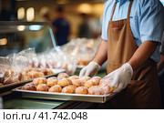 The baker smiles and offers fresh pastries on a tray. Generated by AI. Стоковое AI-изображение, AI-художник Ярославский Максим / Фотобанк Лори