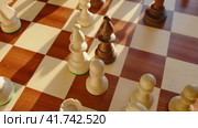 Capture of a white knight by a chess black bishop on a chessboard, stop motion. Стоковое видео, видеограф Андрей Журавлев / Фотобанк Лори