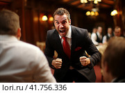 Frustrated businessman expresses anger and disappointment as his partner violates agreed upon terms. Стоковое AI-изображение, AI-художник Юрий Поздников / Фотобанк Лори