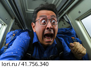 Nervous passenger experiencing intense fear as the airplane encounters turbulent shaking mid flight. Стоковое AI-изображение, AI-художник Юрий Поздников / Фотобанк Лори