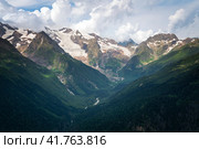 View of the Alibek Gorge, the Alibek River and the mountains of the Main Caucasian Ridge, opening from the upper station of the cable car system of the Dombay ski resort, Karachay-Cherkessia, Russia. Стоковое фото, фотограф Ula Ulachka / Фотобанк Лори