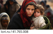 Portrait of Refugees on middle east looking at camera. Homeless people, unhappy and frightened, shawl camps,  Generative AI. Стоковое AI-изображение, AI-художник Анна Кривицкая / Фотобанк Лори
