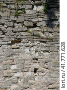 Stone wall texture. Weathered surface of the ancient fortress wall. Uneven rough cracked stonework. An old protective cross is visible in the masonry. Perfect for background and design. Стоковое фото, фотограф Андрей Степанов / Фотобанк Лори