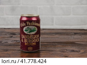 A vintage aluminium can of Olde Fashioned beer against the brick wall. Krasnodar, Russia November 4, 2020. Редакционное фото, фотограф Воловодов Владимир / Фотобанк Лори