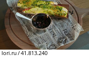 Fish dish with greens served over charcoal, wooden rotating tray, parchment paper in background (2023 год). Редакционное видео, видеограф Даниил Хабаров / Фотобанк Лори