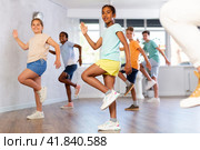 Energetic african american tween girl practicing vigorous dance in group class. Стоковое фото, фотограф Яков Филимонов / Фотобанк Лори