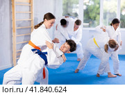 Teenage girl practicing fighting techniques during martial arts sparring with boy. Стоковое фото, фотограф Яков Филимонов / Фотобанк Лори