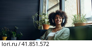 Young dark skinned women sitting near windows listening music with headphones. Banner. Copy space. Стоковое AI-изображение, AI-художник Наталья Семкина / Фотобанк Лори
