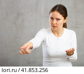 Indignant adult woman girl gesturing in studio. Стоковое фото, фотограф Яков Филимонов / Фотобанк Лори