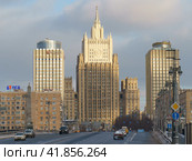Moscow, Russia - February 5, 2021: Cityscape in winter day. Stalinist architecture building of Ministry of foreign affairs (MFA) and Borodinsky Bridge. Smolenskaya subway station. Редакционное фото, фотограф YuryKara / Фотобанк Лори